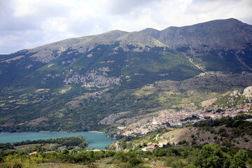 Fototapeta na wymiar View from above of the small village in the mountains on the lake, Barrea, Abruzzo National Park, Italy