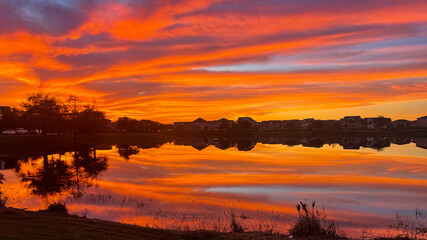Fototapeta premium Beautiful pink, orange and blue sunset reflecting on a lake