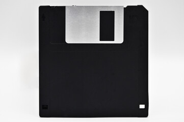 Old computer and data storage technology, black magnetic floppy disk 3½ inches, isolated on white...