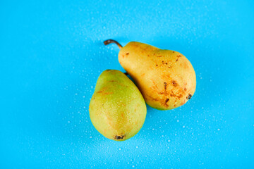 Fototapeta na wymiar Fresh ripe pears isolated on blue background