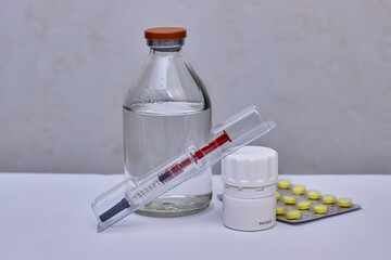 Syringe, bottle and pills. Preventive vaccination of people. Treatment of disease.