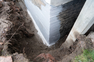 Waterproofing foundation of an old house.