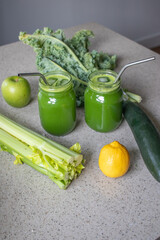 Green Juice with fresh produce on countertop 