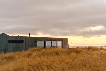 Obraz premium facade of a designer building made of wood on the seashore.