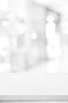 Vertical white table presentation, desk and blur background, Empty wood counter, shelf surface over blur restaurant white bokeh background, Wood table top for retail shop, store product display banner