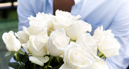 Young man holding white roses for surprising in love  romantic in valentine day