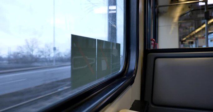 Seat window on the moving train cross the river on the bridge and view of cityscape of D&uuml;sseldorf, Germany through window. Enjoy outdoor scenery moment during journey and travel by train. 