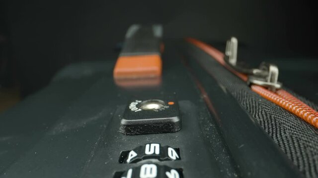 The lock keys on the luggage bag with the numbers on it and the zipper on the side