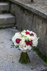 Beautiful bridal bouquet of red roses and white freesia.