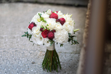 Beautiful bridal bouquet of red roses and white freesia.