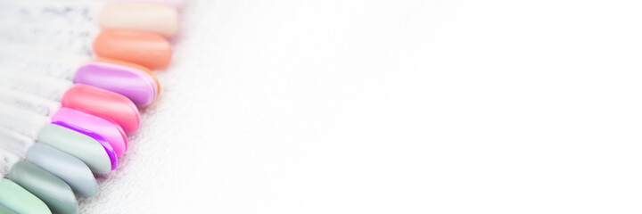 Defferent nail gel wheel sample on white background. Beautiful salon procedure with pink pedicure...