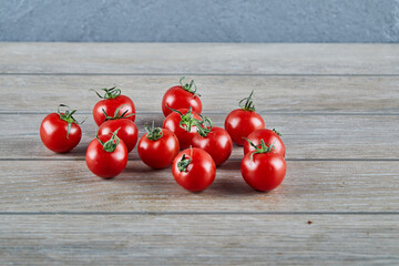 Bunch of fresh juicy tomatoes on wooden table