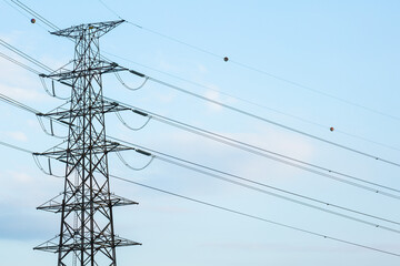 Silhouette of High voltage pole  on blue sky background