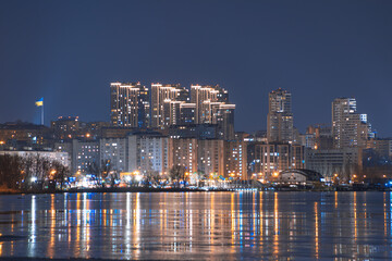 Obraz premium Beautiful city at night. Night city reflected in the water.