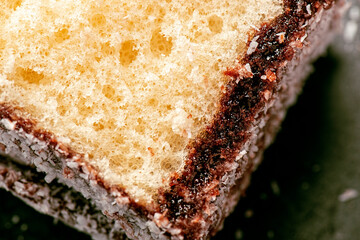 Delectable lamington, made with sponge cake, chocolate sauce and shredded coconut