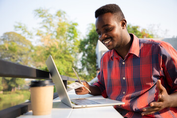 African american handsome man using laptop for business and tranfer money online or manual. Success economy concept