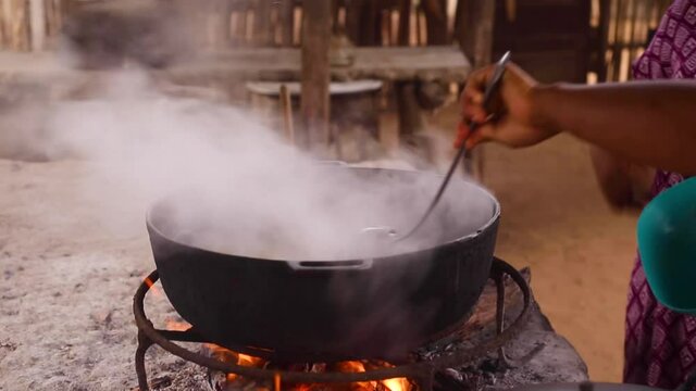 A woman cooking with charcoal and fire. Guajira, Colombia