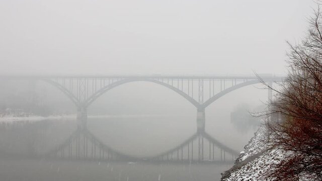 bridge over frozen cold mississippi river on winter snowstorm midwest minnesota usa united states of america