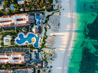 Aerial drone view of beach resort hotels with pools, umbrellas and blue water of Atlantic Ocean,...