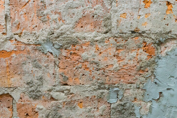 damaged red bricks wall with concrete texture