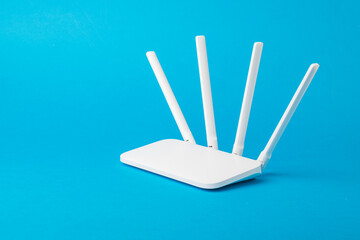 Modern stylish Wi-Fi router on a light blue background. - obrazy, fototapety, plakaty