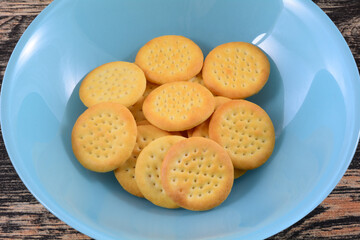 Closeup of South African cheese biscuits in blue snack bowl