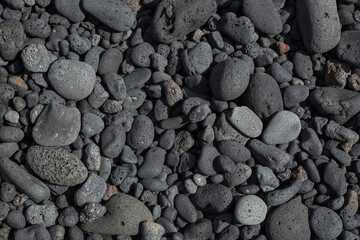 Washed Gray Stones Of Volcanic Origin On The Beach