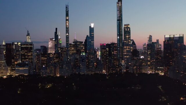 Wide Angle View of whole New York City Skyline flashing City lights at Night, Aerial Establishing Shot