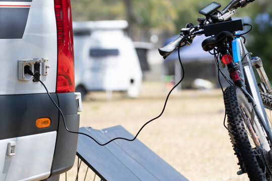 Electric  Bicycle Battery Being Charged From RV Campervan Using Solar Energy And Inverter System