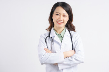Portrait of Asian female doctor holding hands and smiling - Powered by Adobe