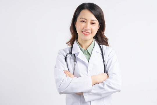 Portrait of Asian female doctor holding hands and smiling