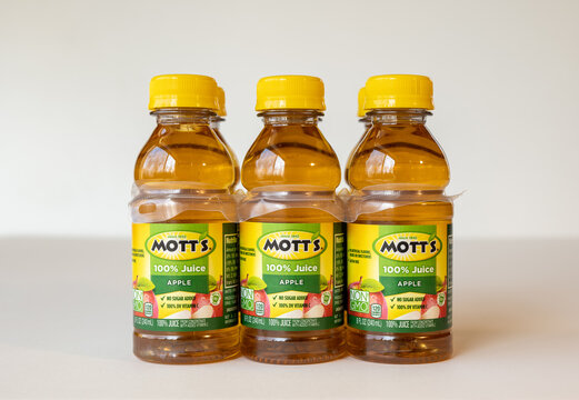 BEMIDJI, MN - 17 NOV 2020: Plastic bottles of Motts apple juice in 6 pack state the product contains 100 percent juice.
