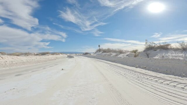 Sandy road meets asphalt at White Sands in New Mexico