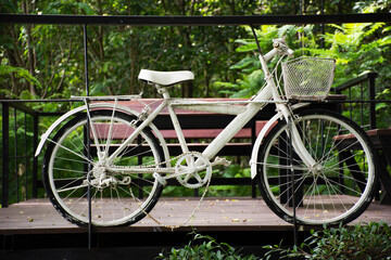 Fototapeta na wymiar Old white classic vintage retro bicycle exterior decoration furniture of garden outdoor for travelers visit at Phu Foi Lom in Pa Phan Don National Forest Reserve at Nong Saeng in Udon Thani, Thailand