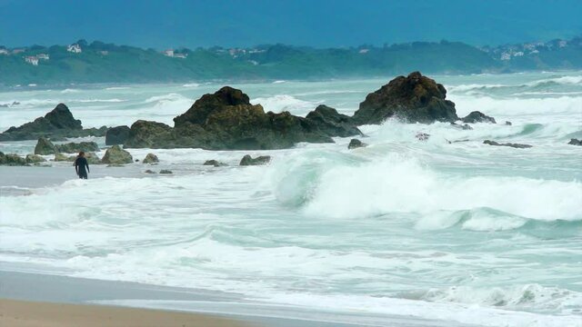 Waves crashing over rocks in the sea in super slow motion. 

Filmed during surf comp at Biaritz beach in France.
