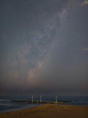 Milky way galaxy rising above the beach.