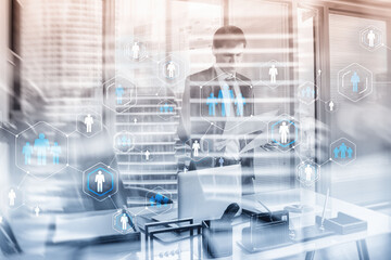 Blue people icons on the background of businessmen working in the office.