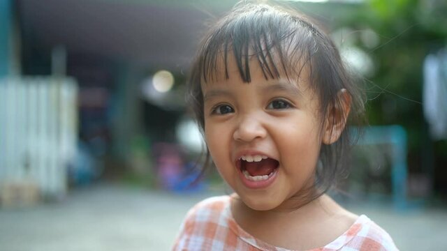 Asian little girl is smiling with happiness.