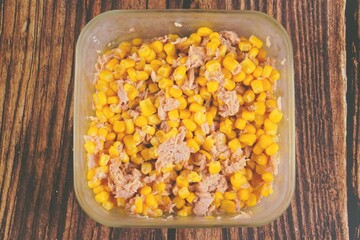 A bowl of corn and tuna mixed salad