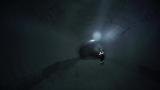 Engineers of geology and mining walking inside tunnel mine