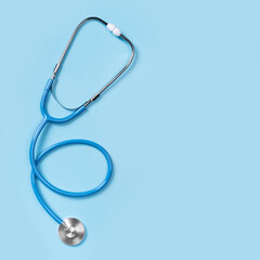 Stethoscope isolated on blue, top view. Medical tool. Medical tool. stethoscope is an important diagnostic tool, copy space. square image. Flat lay, top view