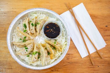 Dumplings or Potstickers with soy sauce in Aluminium Foil Container.