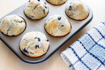 Homemade freshly baked muffins with berries in pan