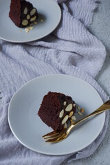 slice of chocolate cake in a plate in grey background