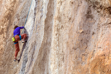 girl climbs a rock-climbing route. outdoor sports.