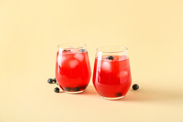 Glasses of fruit ice tea on color background