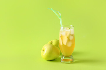 Glass of fruit ice tea on color background