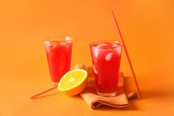 Glasses of fruit ice tea on color background