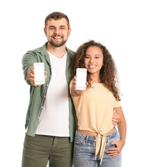 Young couple with mobile phones on white background