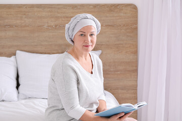 Mature woman after chemotherapy reading book at home